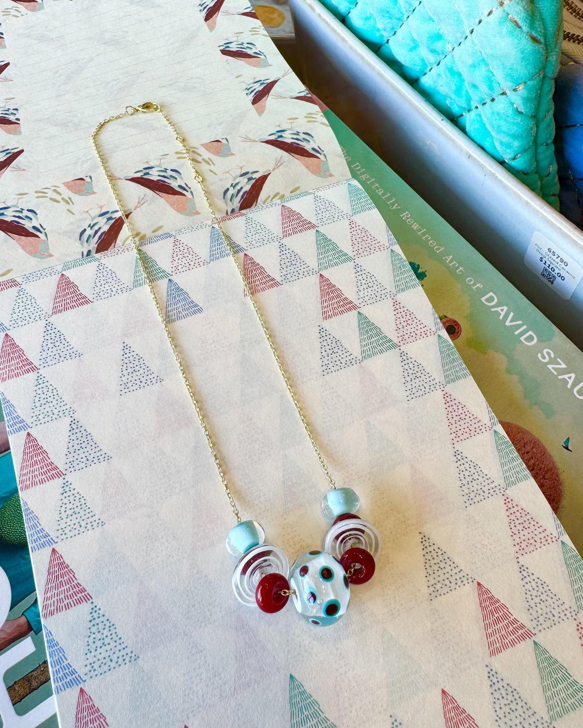 “Statement” Lifesaver Glass Bead Necklaces
The “Statement” necklaces are the most dramatic expression of our playful Lifesaver Series. Each one features an especially large, intricately designed key element bead that serves as the centerpiece of the necklace. These impressive focal beads are even more substantial and detailed than the “Fancy” beads, creating a bold presence while still maintaining the joyful spirit of the collection.
The graduated sizes and varied shapes of the surrounding Lifesaver beads