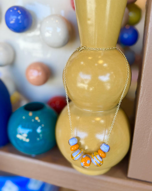 “Fancy” Lifesaver Glass Bead Necklaces
The “Fancy” necklaces are part of our playful Lifesaver Series, featuring more intricately designed key element beads that add an especially artful touch to each one-of-a-kind piece.
The graduated sizes and varied shapes of the Lifesaver beads create beautiful movement when worn. Some necklaces feature joyful monochromatic color combinations, while others mix vibrant colors for a more energetic, expressive look. Within each design, the intricate “Fancy” beads serve a
