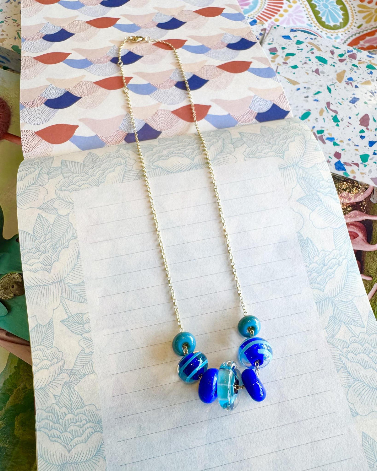 “Fancy” Lifesaver Glass Bead Necklaces
The “Fancy” necklaces are part of our playful Lifesaver Series, featuring more intricately designed key element beads that add an especially artful touch to each one-of-a-kind piece.
The graduated sizes and varied shapes of the Lifesaver beads create beautiful movement when worn. Some necklaces feature joyful monochromatic color combinations, while others mix vibrant colors for a more energetic, expressive look. Within each design, the intricate “Fancy” beads serve a