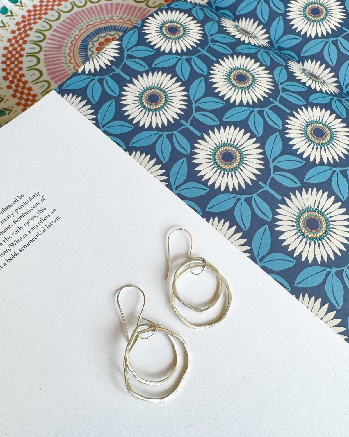 Double Circle Sterling Silver Dangle Earrings
Elegant and sculptural, these sterling silver earrings feature two open circles that dangle in a graceful, slightly offset arrangement. The circles are subtly different in size, creating natural movement and an easy, artful silhouette.