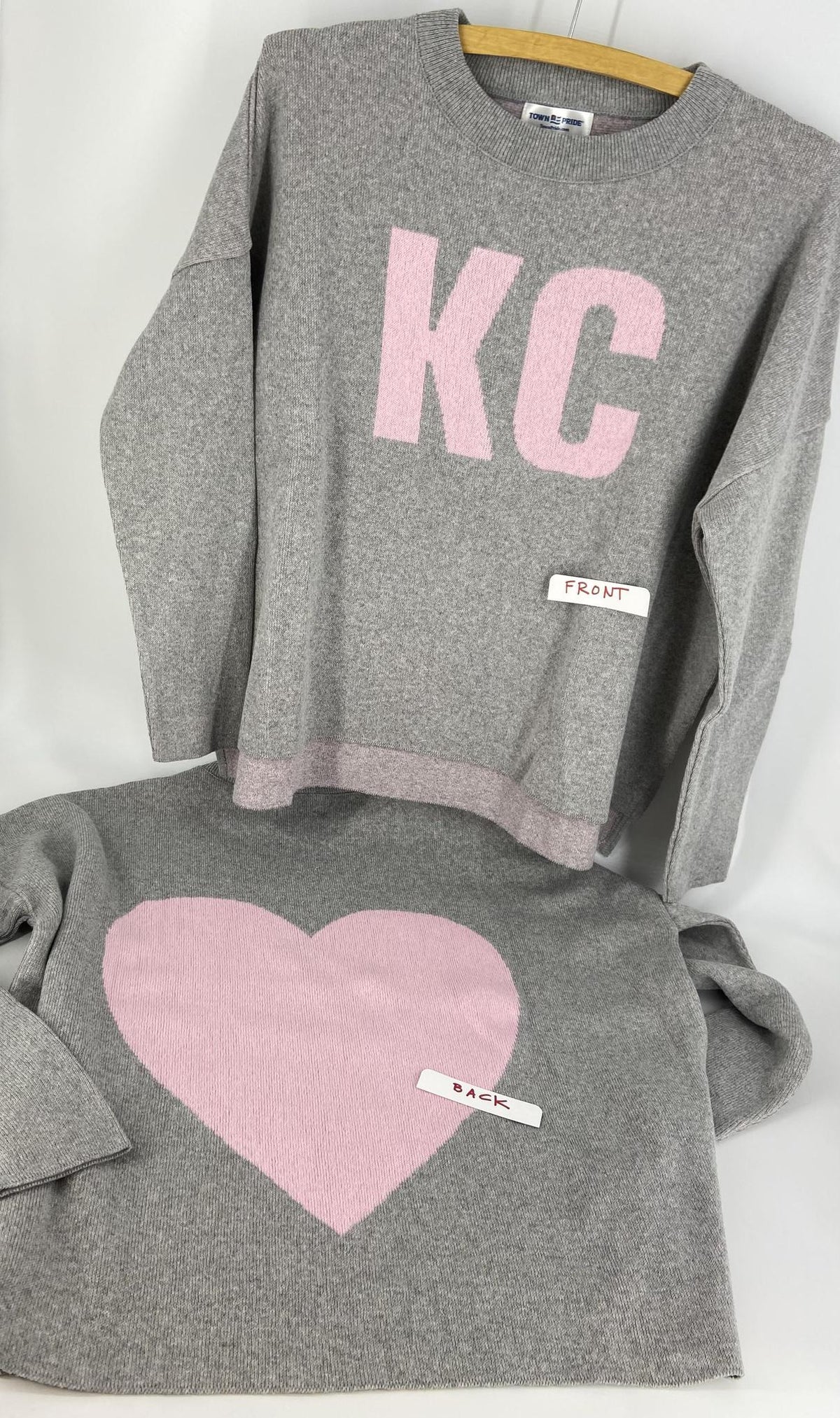 Grey and pick sweater featuring KC on front and giant heart on back.