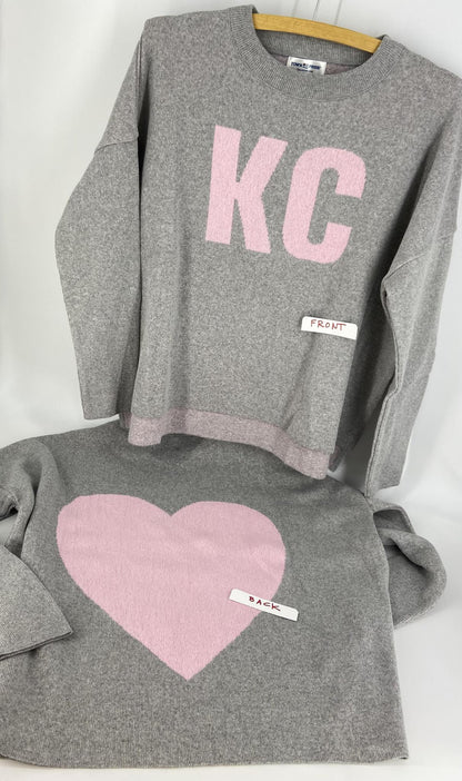 Grey and pick sweater featuring KC on front and giant heart on back.