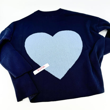 A navy pullover sweater with 'KC' written on the front and a heart shape on the back, displayed on a hanger.