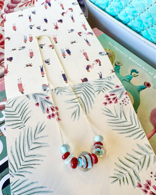 “Statement” Lifesaver Glass Bead Necklaces

The “Statement” necklaces are the most dramatic expression of our playful Lifesaver Series. Each one features an especially large, intricately designed key element bead that serves as the centerpiece of the necklace. These impressive focal beads are even more substantial and detailed than the “Fancy” beads, creating a bold presence while still maintaining the joyful spirit of the collection.

The graduated sizes and varied shapes of the surrounding Lifesaver beads